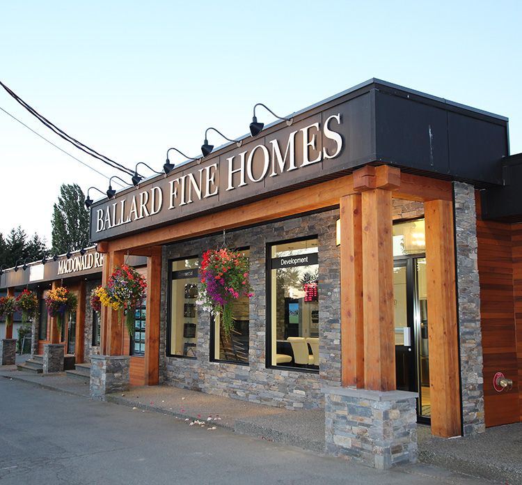 Photo of Ballard Fine Homes storefront with blue skies in the background